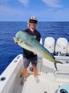 an angler holding a dolphinfish caught off Florida's east coast