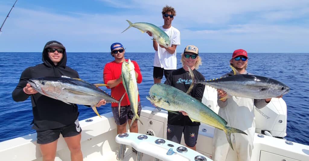 anglers holding yellowfin tuna and dolphin caught off Florida's east coast