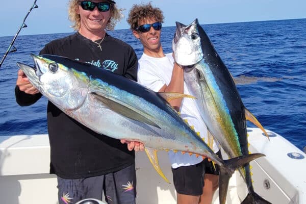 two anglers hold yellowfin tuna caught across the Gulf Stream off Florida East Coast