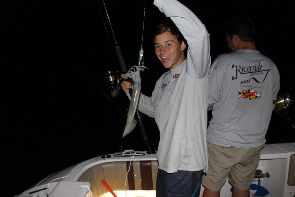 Angler holds up squid he caught during a night fishing trip