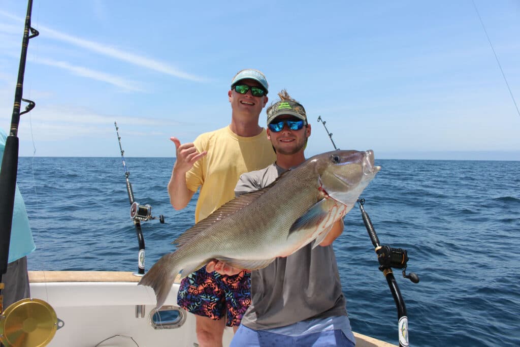 two anglers posing with a large blueline tilefish
